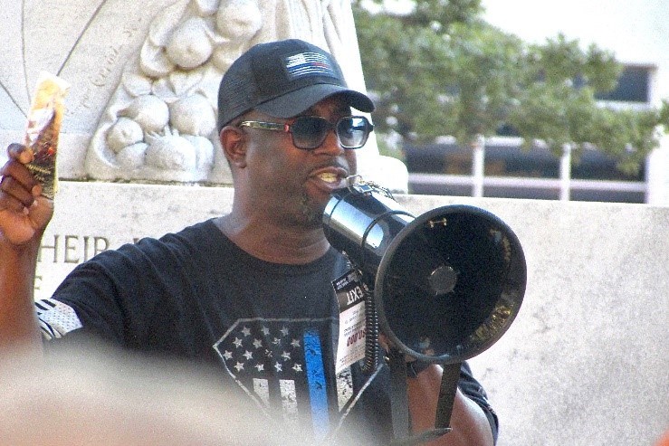Dr. Tim Westley Speaking though at megaphone outside at the Alamo Cenotaph Rally